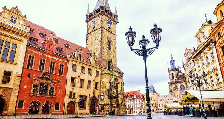 Prague's Old Town Square featuring historic architecture and a clock tower.