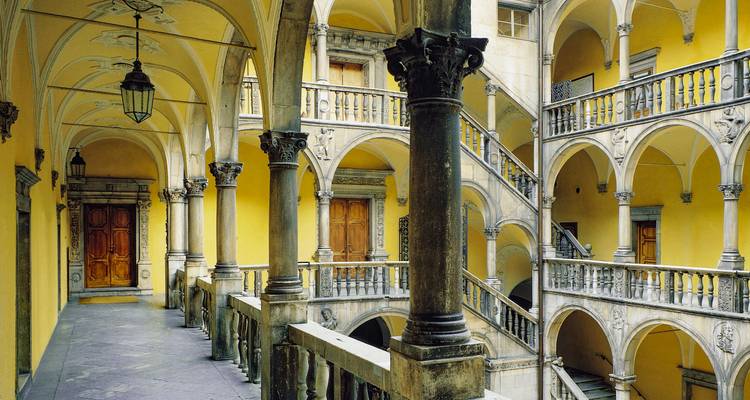 Architectural details of a historic yellow courtyard.
