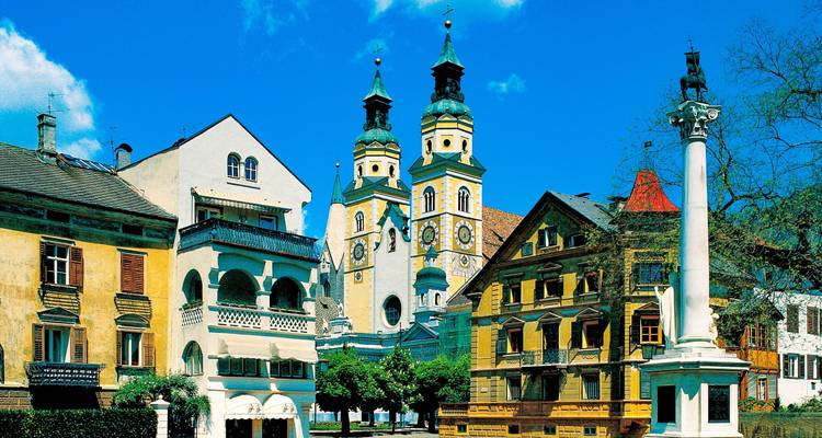 Historic town square with ornate buildings and a church.