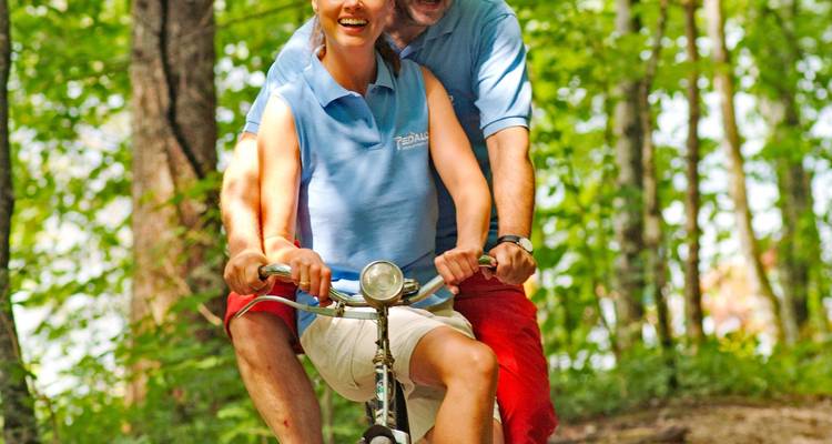 Couple enjoying a leisurely bicycle ride in the forest.