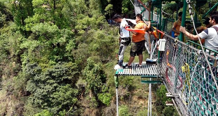 People standing on a bungee jumping platform.