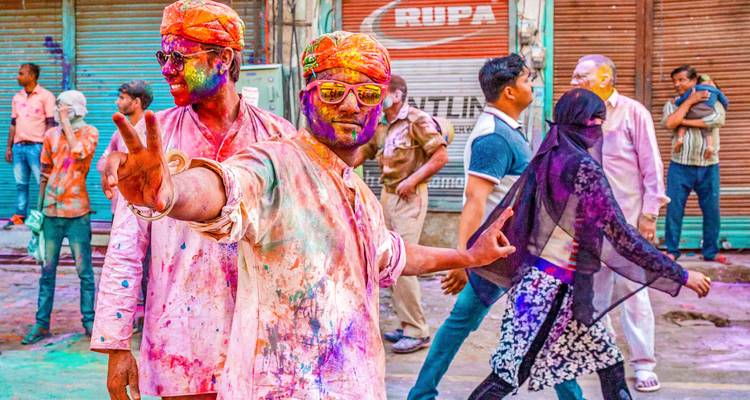 Des hommes célébrant le festival de Holi avec des couleurs sur leurs visages.