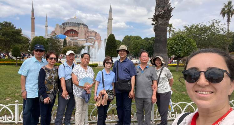 Group posing in front of a large mosque.