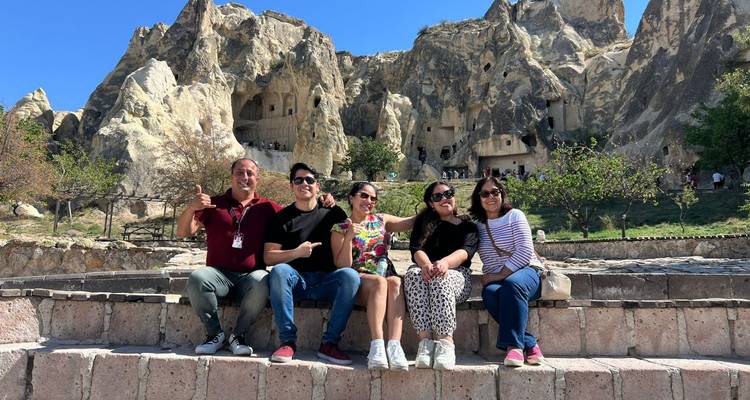 Group sitting in front of rock formations.