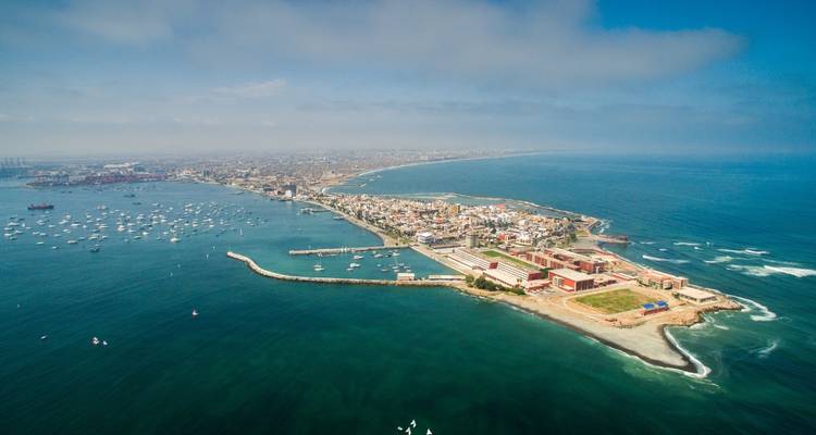Aerial view of a coastal area with a city skyline.