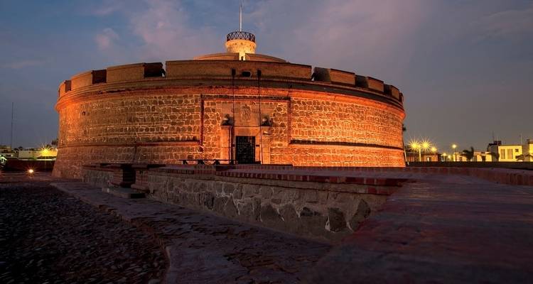 A round fort-like structure with lights, potentially a historical site.