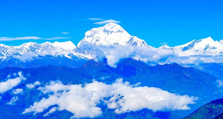 Majestic mountain peak surrounded by clouds.