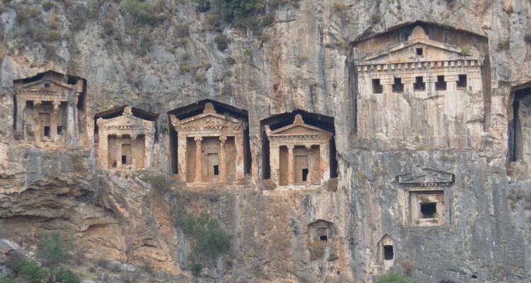 Ancient rock tombs carved into a cliff face.