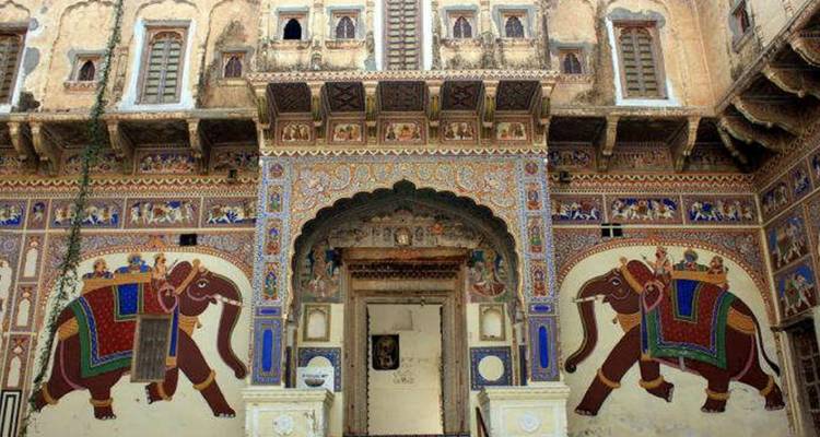 Decorative entrance of a historic building with colorful murals