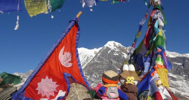 Prayer flags with snowy mountain background.