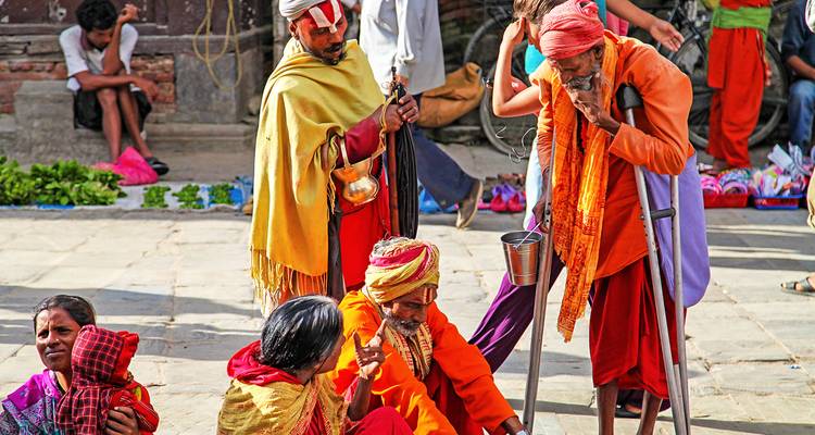 Elderly people sitting and conversing on a street