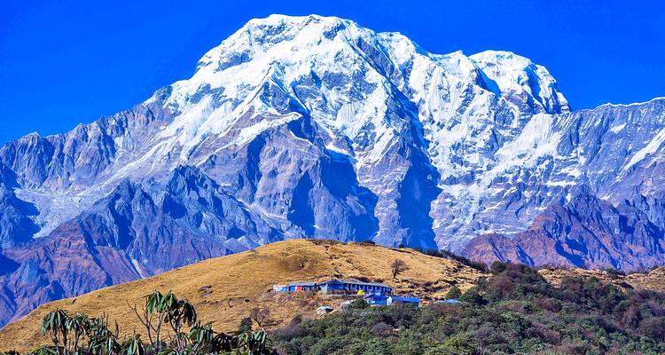 A majestic snow-capped mountain under a clear blue sky
