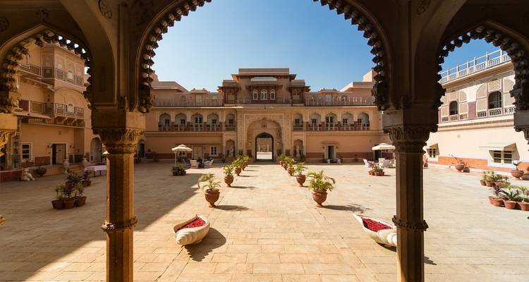Palatial courtyard with ornate architecture and open space.