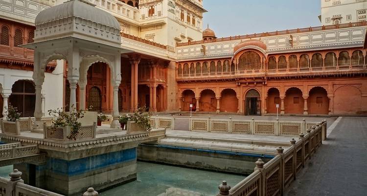 Intricate courtyard with a pool and architectural details.