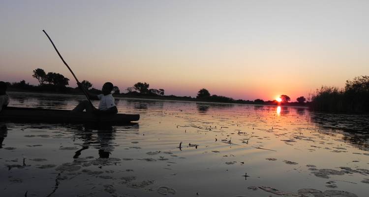 Sunset view with mokoro on the water.