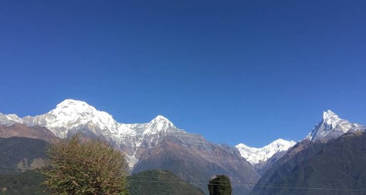 Clear view of the Annapurna mountain range under a blue sky.
