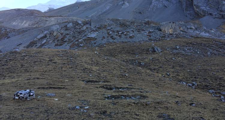 Barren mountainous terrain under a clear sky.