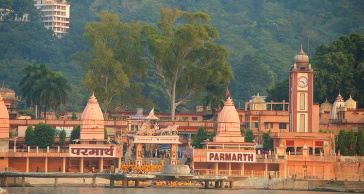Parmarth Niketan Ashram and surrounding buildings by a river.