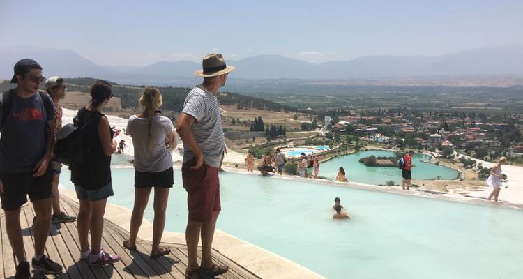 People enjoying a view of the terraces and pools in Pamukkale.