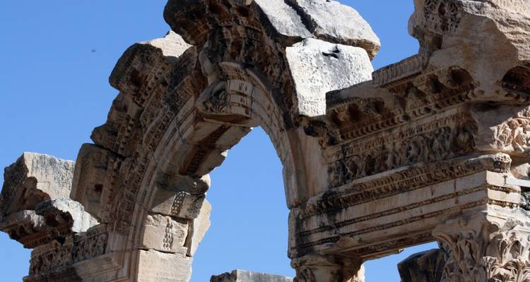 Close-up of an ancient stone arch with detailed carvings.