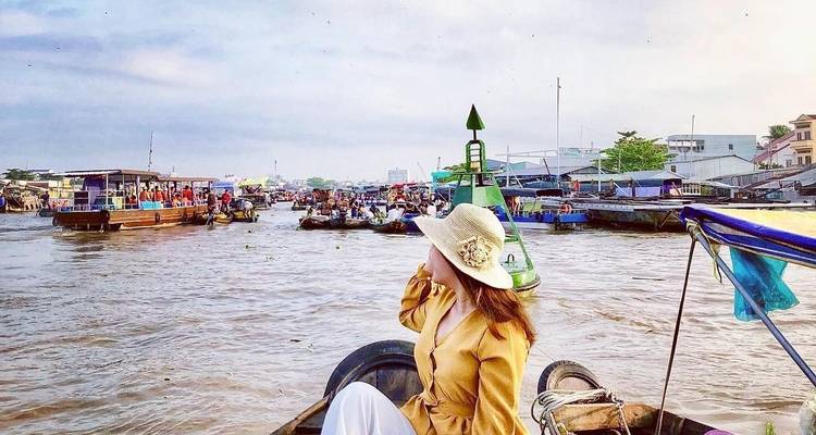 Woman enjoying a view of a bustling river market.
