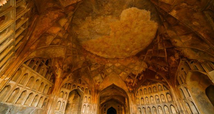 Dome ceiling with worn, intricate designs and pattern work.