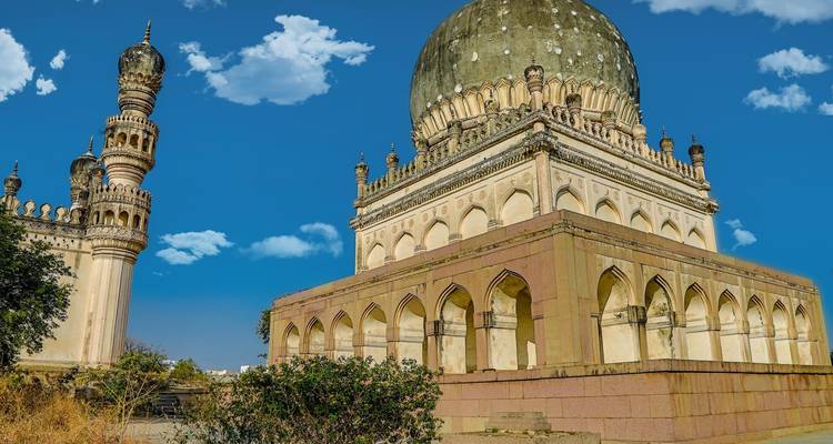 Historic monument with a large dome and minarets under a blue sky.