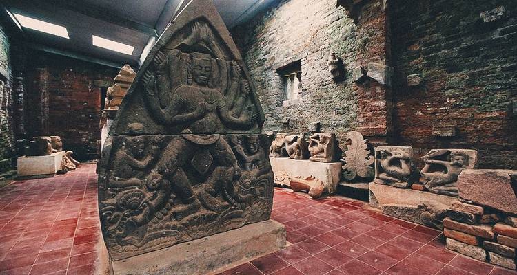Indoor museum with ancient sculptures on display.