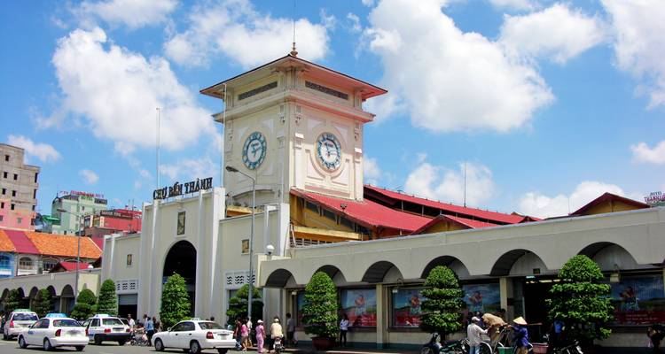 Ben Thanh Market entrance with bustling street activity.