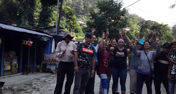 Gruppe von Wanderern, die in einer ländlichen Umgebung mit viel Grün posieren.