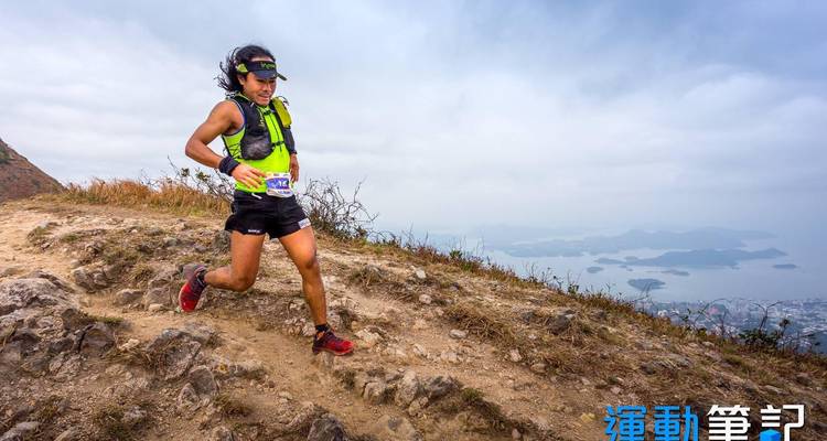 Trail runner on a rugged mountain path.