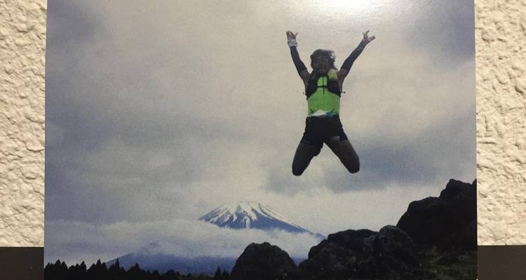 Person jumping with joy in a mountainous landscape.