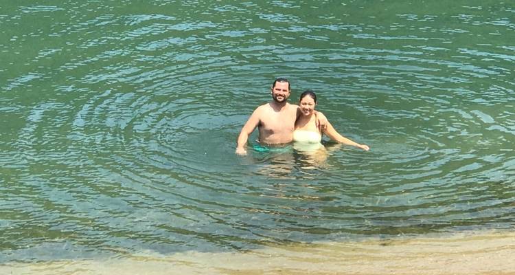 A couple swimming in a clear body of water.