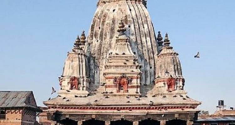 Ornate temple structure with carvings and birds.