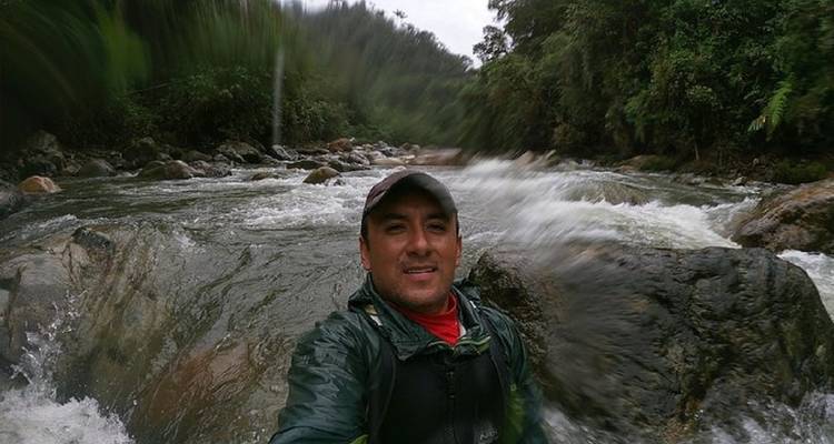 Man posing by a fast-flowing river.