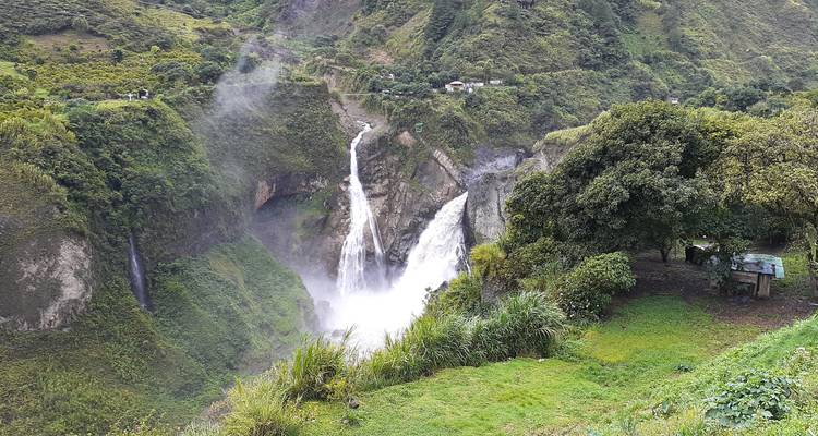 Powerful waterfall in a lush green gorge.