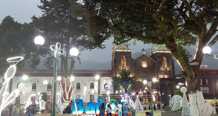 Town square decorated with lights in front of a historic church.