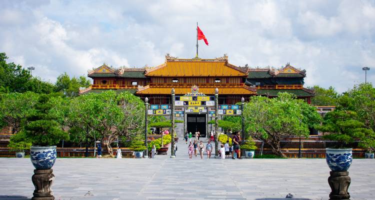 A historic gateway with traditional architecture and tourists.