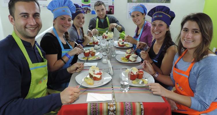 Group of people sitting at a table with decorated dishes.