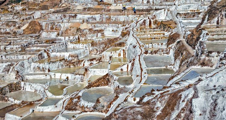 Maras salt ponds with people working.