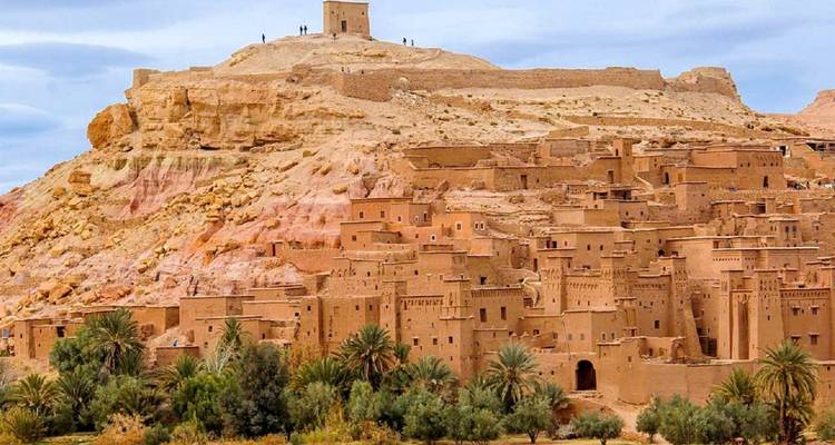 Ait Benhaddou with traditional mud-brick buildings on a hillside.