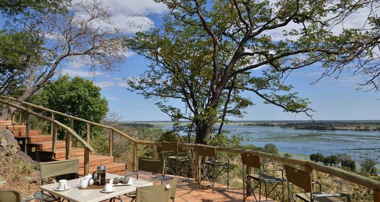 Outdoor dining area with a view of a river.