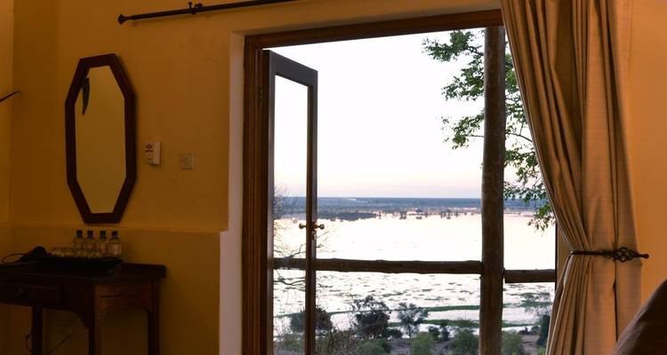View of a river from an open door, inside a accommodation.