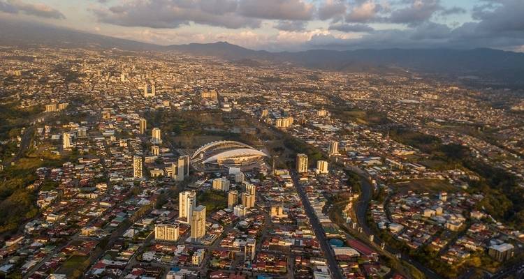 Aerial view of San Jose, Costa Rica, with a stadium and urban landscape during the evening.
