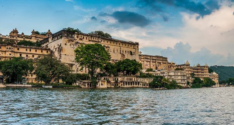 A lakeside view of overlooking palatial structures.