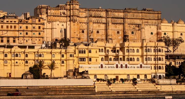 A waterfront view of a fort with palatial architecture.
