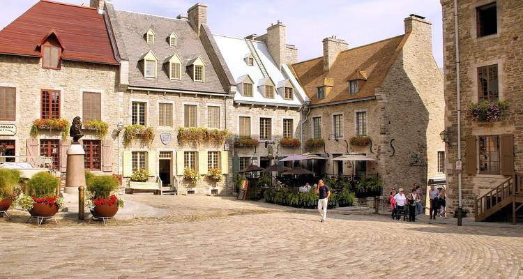 Historical buildings in Quebec City with people walking.