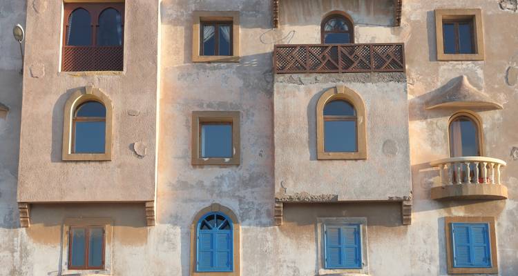 Facade of a building with blue painted windows in Essaouira.