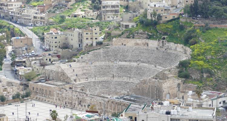 Ancient Roman amphitheater in a city.