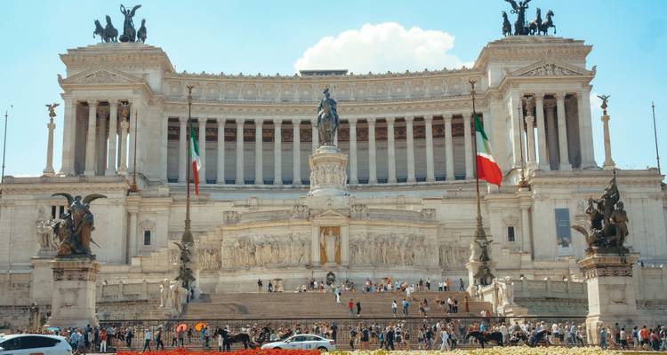 Altare della Patria in Rome with Italian flags and visitors.